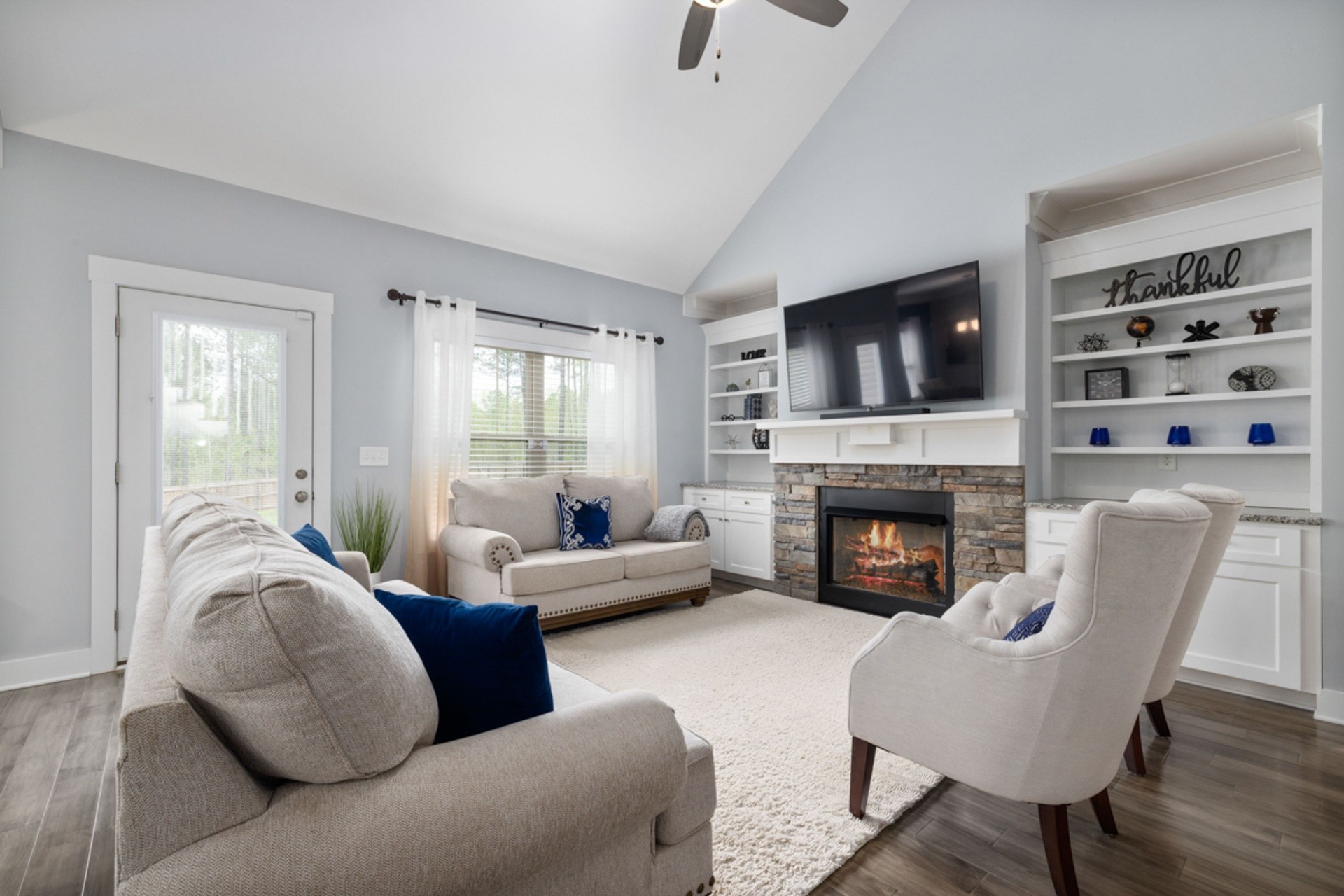 Interior 46193 — vaulted living room with stone fireplace and built-ins