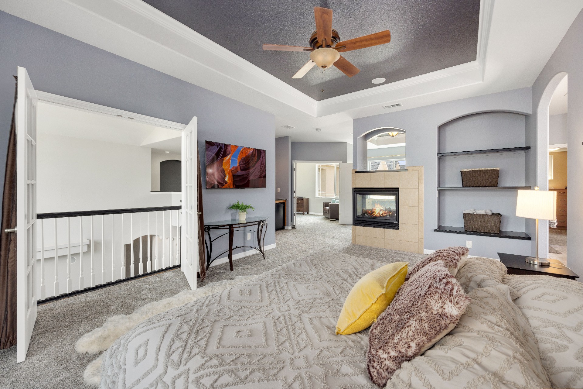 Interior 38157 — loft-style primary suite with fireplace and built-in shelving