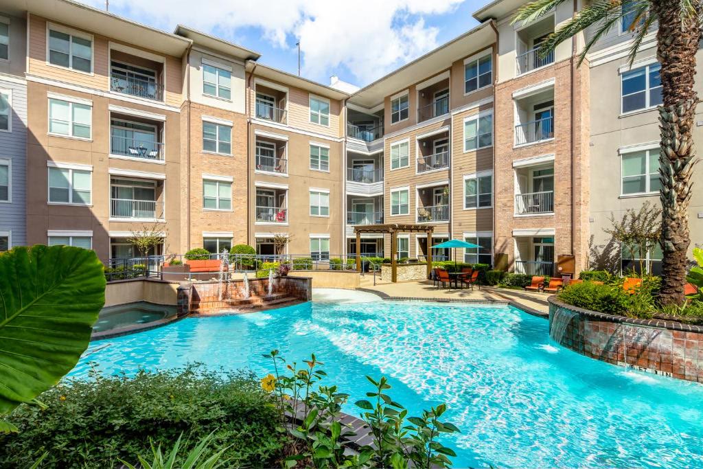 Courtyard apartment pool framed by palms and balconies
