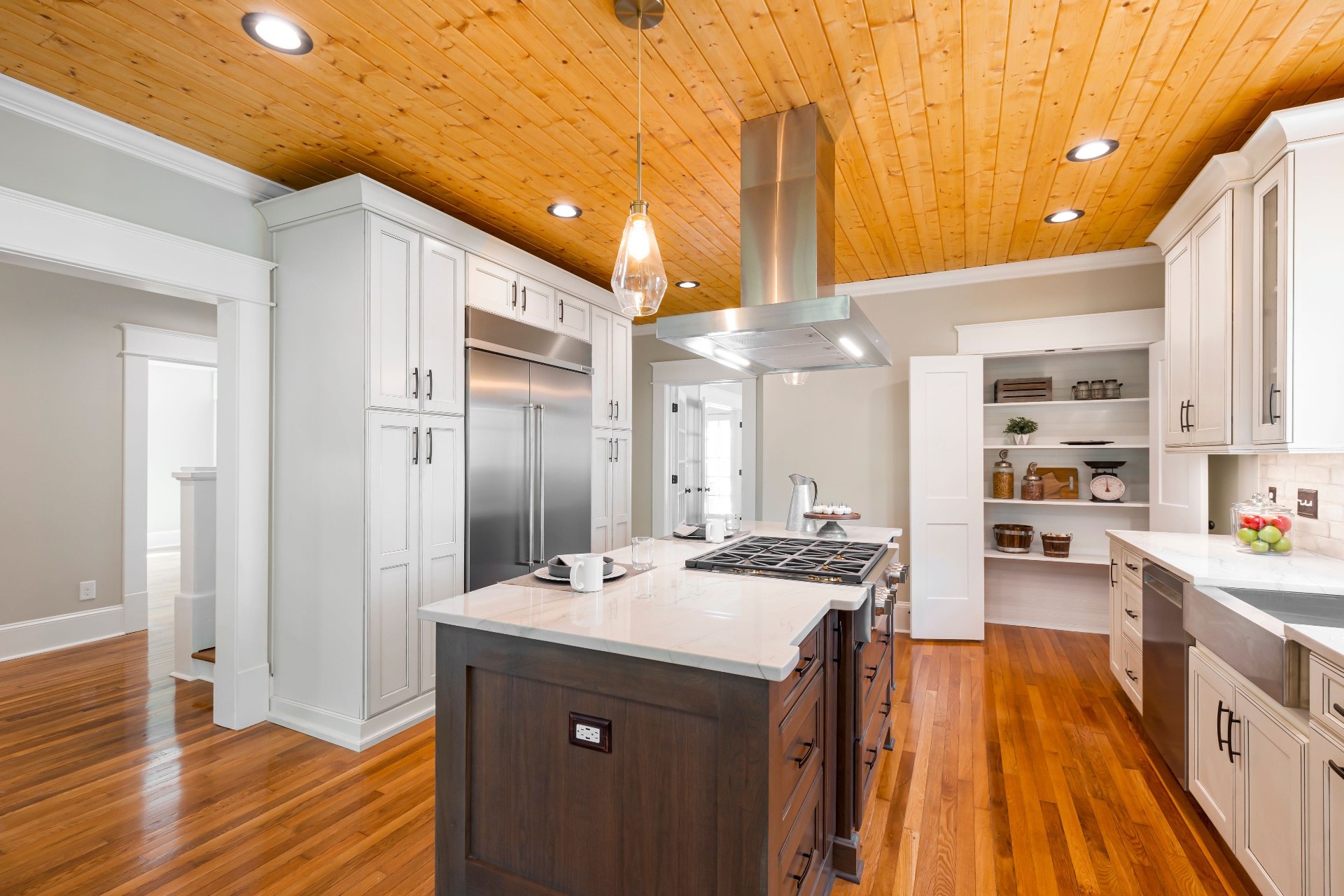 Interior 79215 — chef's kitchen with pine ceiling and island hood