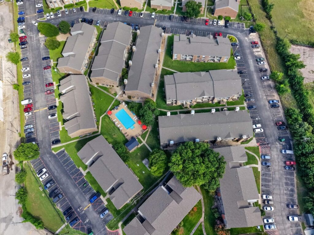 Overhead aerial of apartment complex with central pool