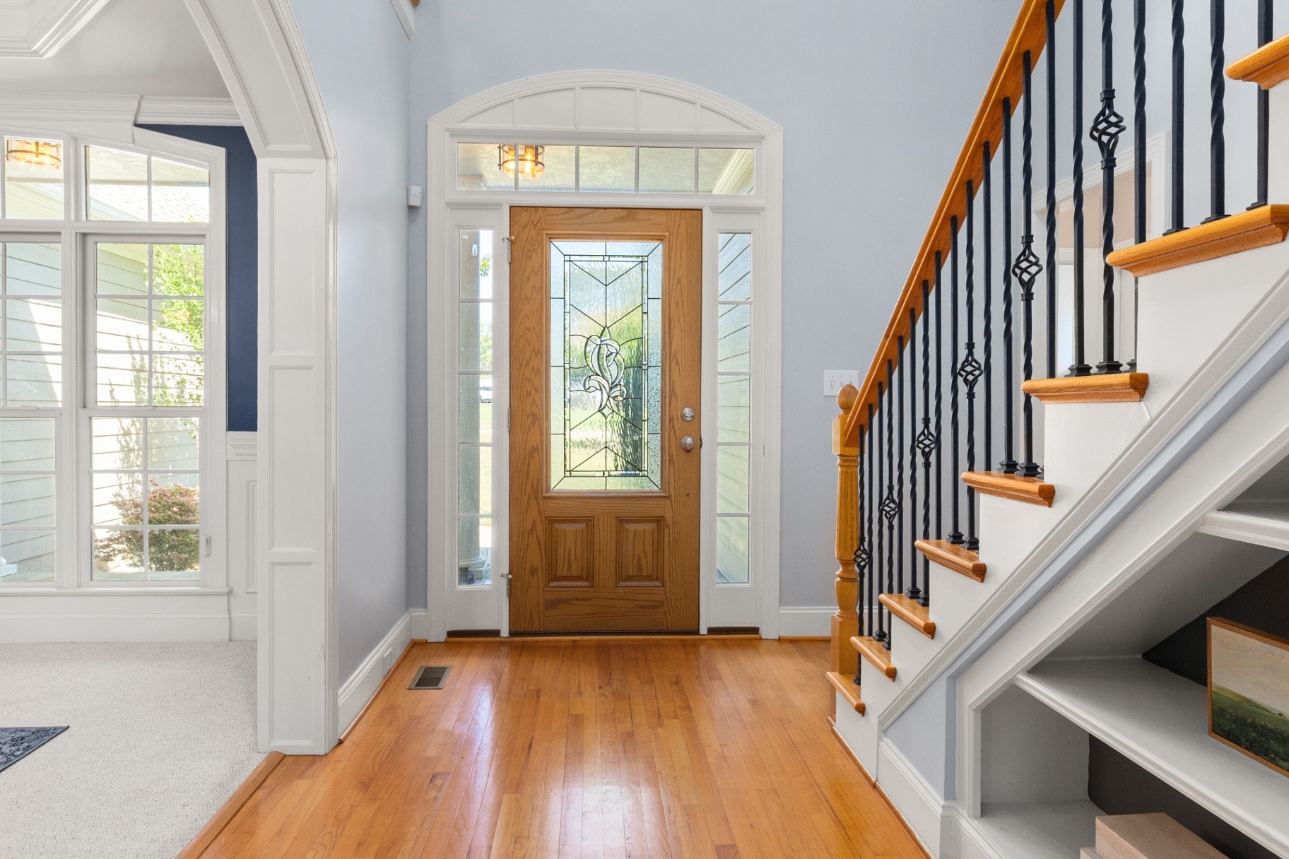 Interior 91425 — two-story foyer with stained glass door and wrought iron railing