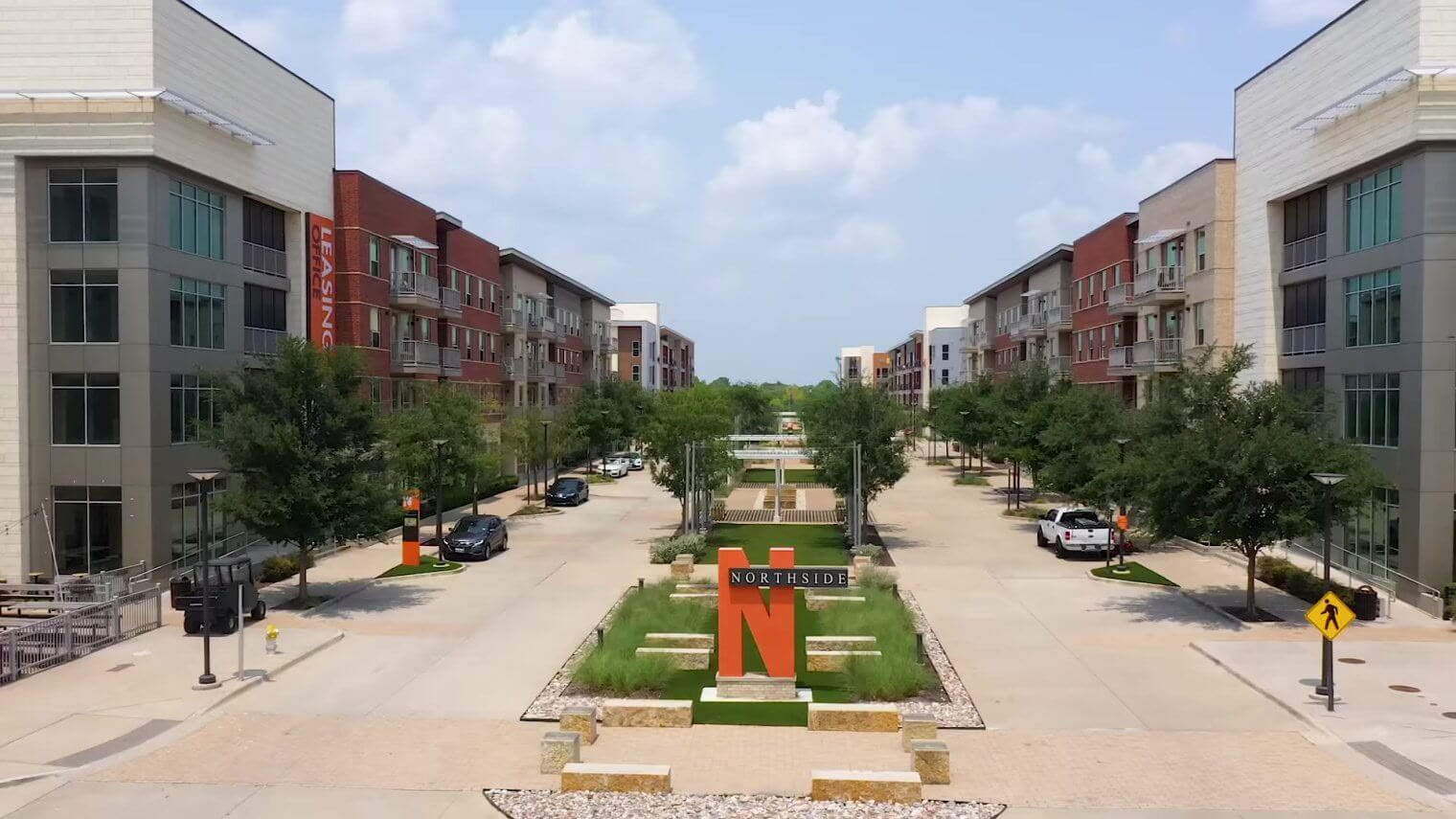 Northside apartment community entrance with landscaped median