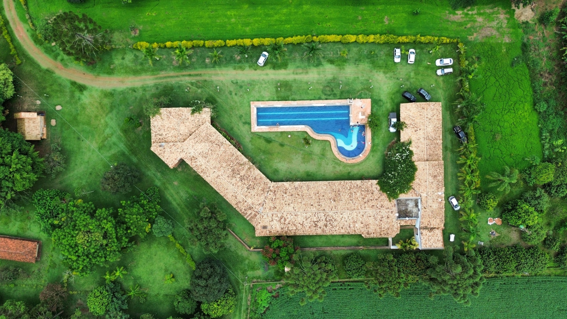 Aerial view of estate with pool and manicured grounds