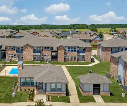 Multi-family community with two-story buildings and green lawns