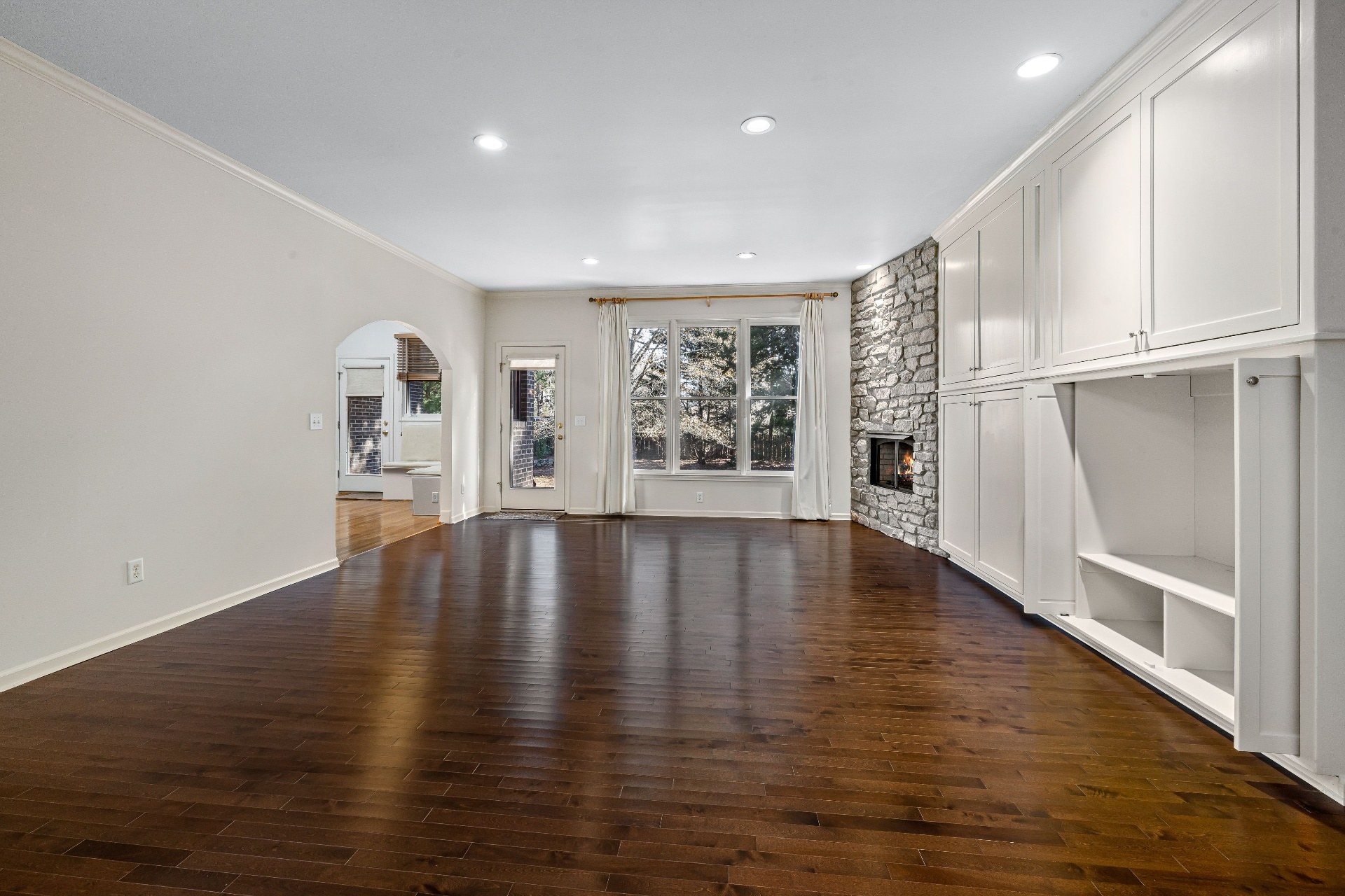 Interior 53820 — great room with dark hardwood and stone hearth